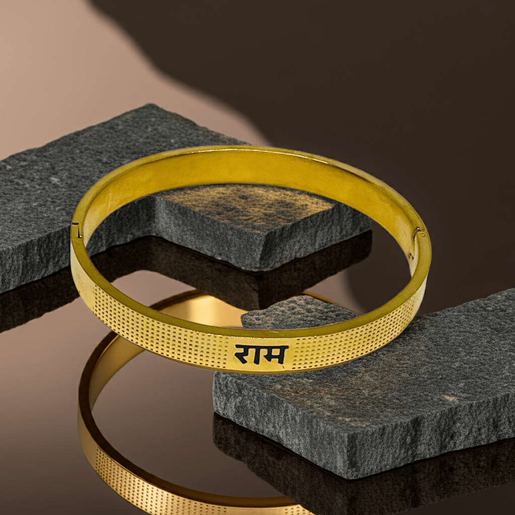 Gold bracelet with engraved Ram on a dark stone surface