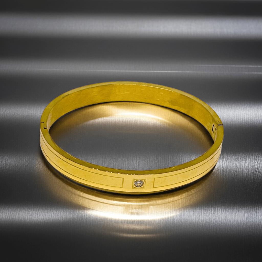 Gold bracelet on a metallic surface