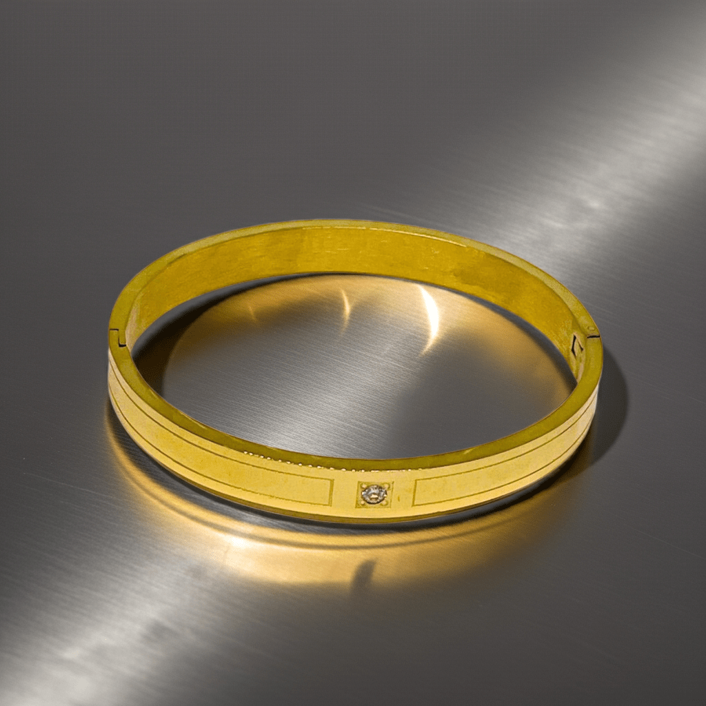 Gold bracelet on a metallic surface