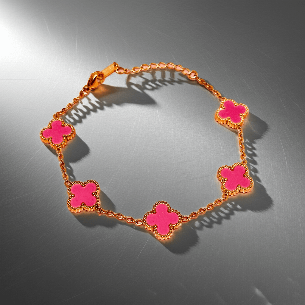 gold clover bracelet waterproof anti-tarnish with pink floral links on a metallic surface