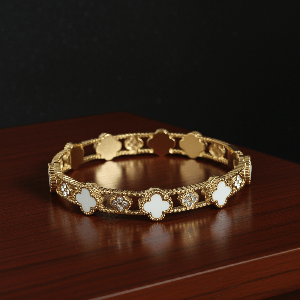 White color clover leaf 18k gold plated bracelet on a wooden counter