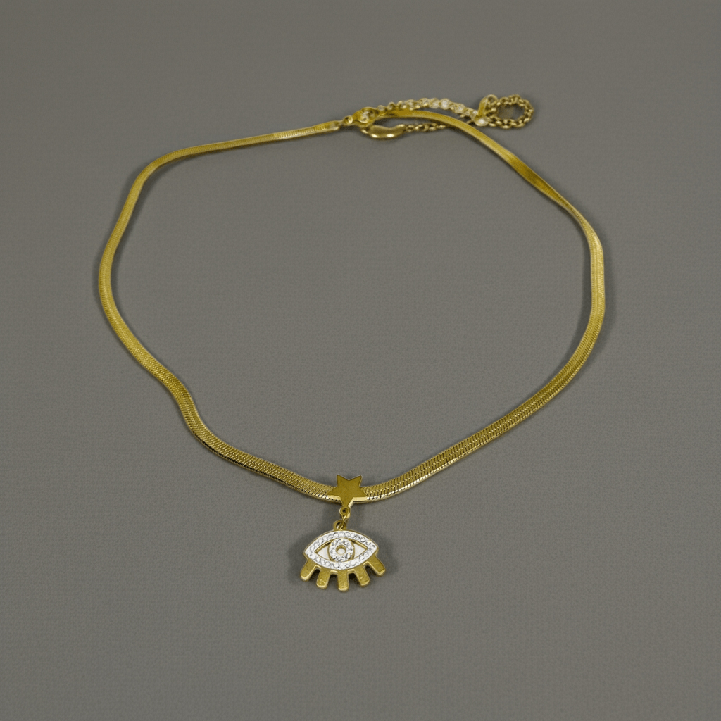 Gold necklace with an eye-shaped pendant on a gray background