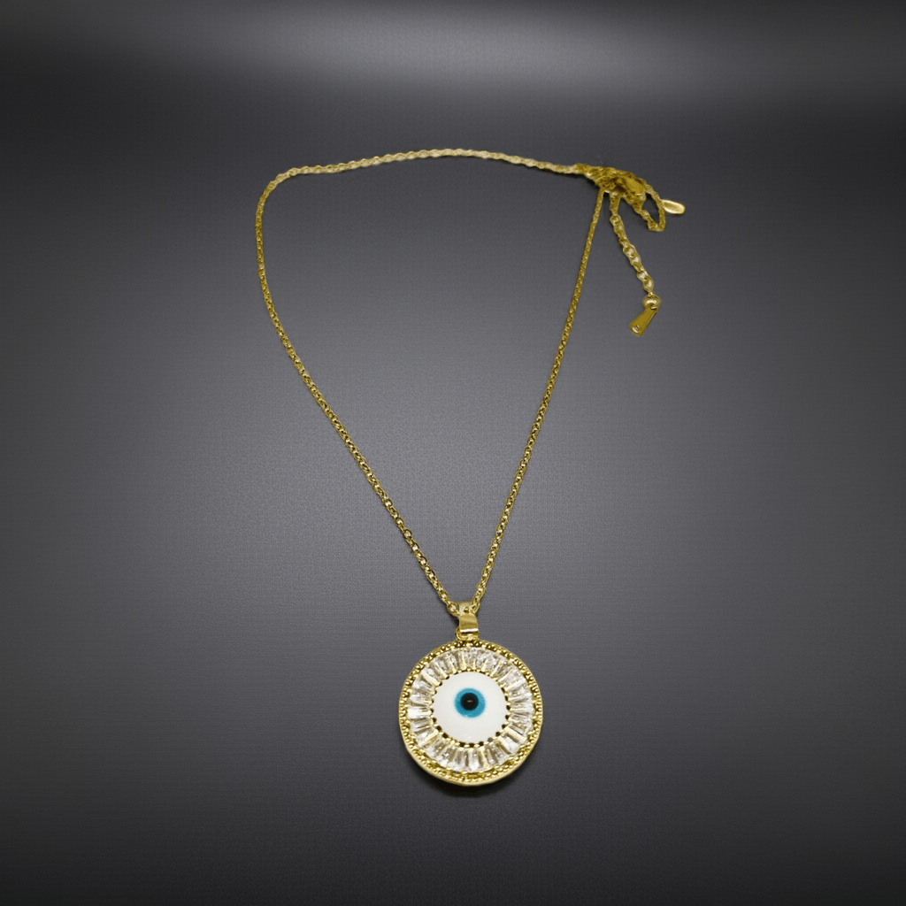 Gold necklace with an eye-shaped pendant on a dark gray background