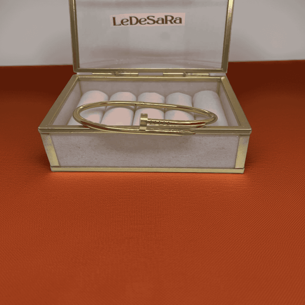 18k Gold Nail bracelet displayed in a LeDeSaRa box on brown satin fabric