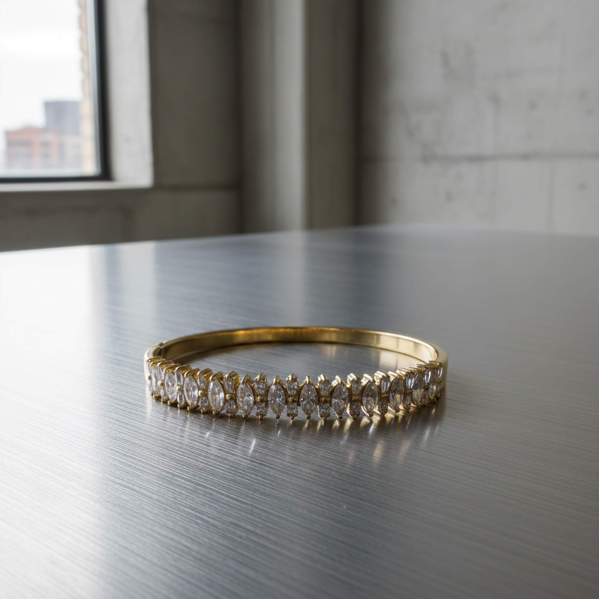 18k Gold bracelet with zirconia diamonds on a reflective surface