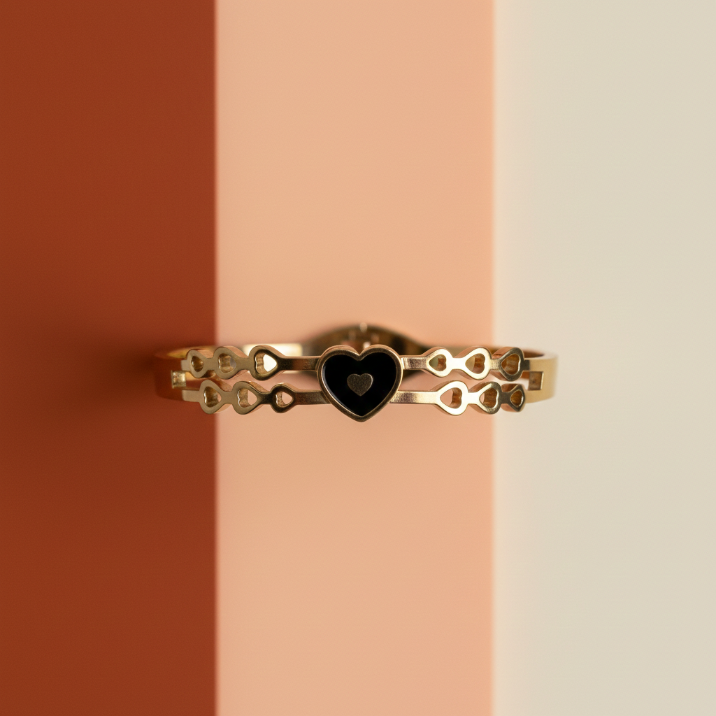 18k Gold plated bracelet with a heart-shaped black stone on a striped background