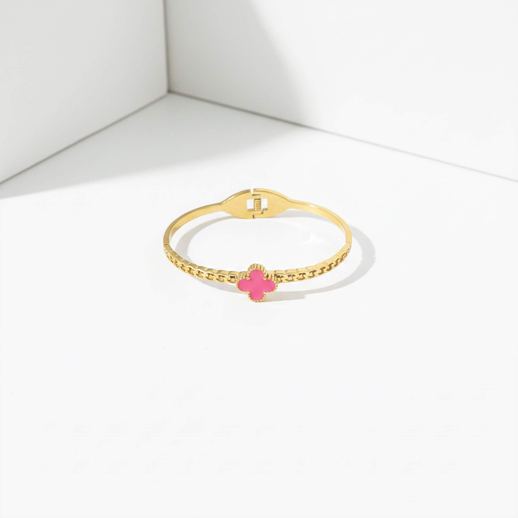 18k Gold plated bracelet with a pink clover charm on a white background