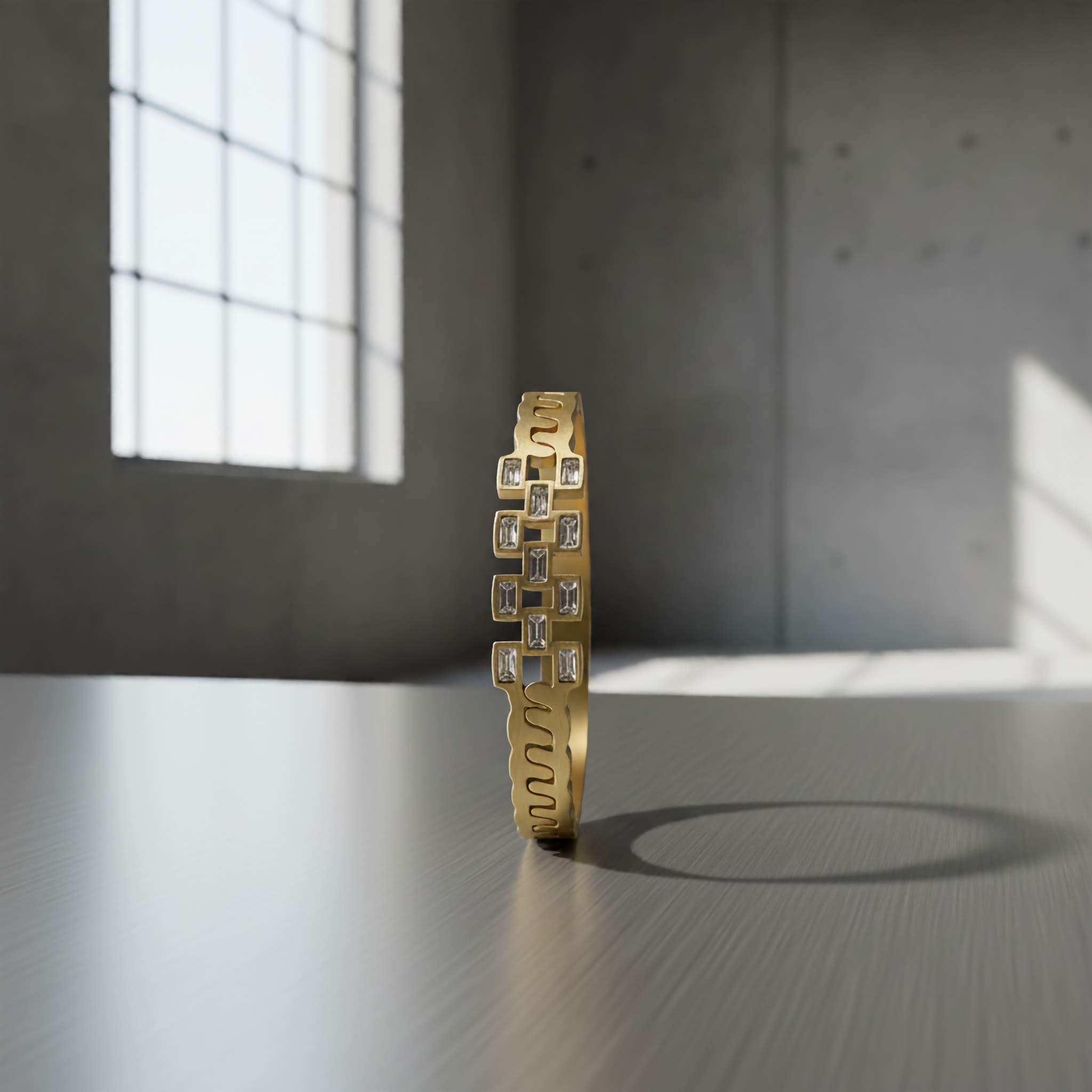 18k Gold plated bracelet with geometric design on a reflective surface with a window in the background