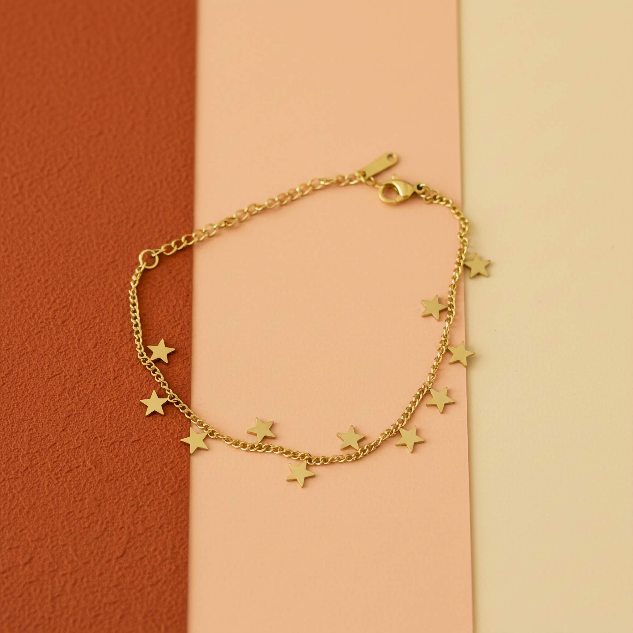 18k Gold plated bracelet with stars charms on a two-tone background