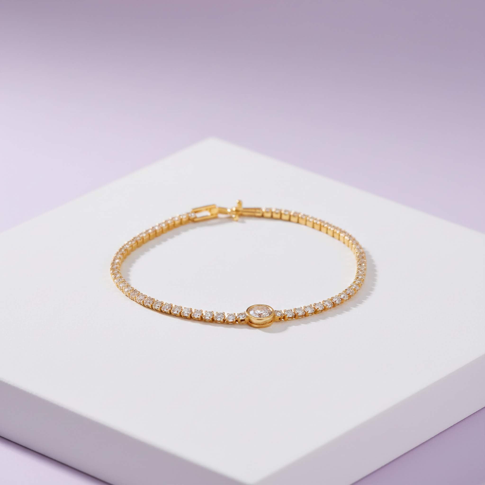 18k Gold plated bracelet with zirconia diamonds on a light purple background