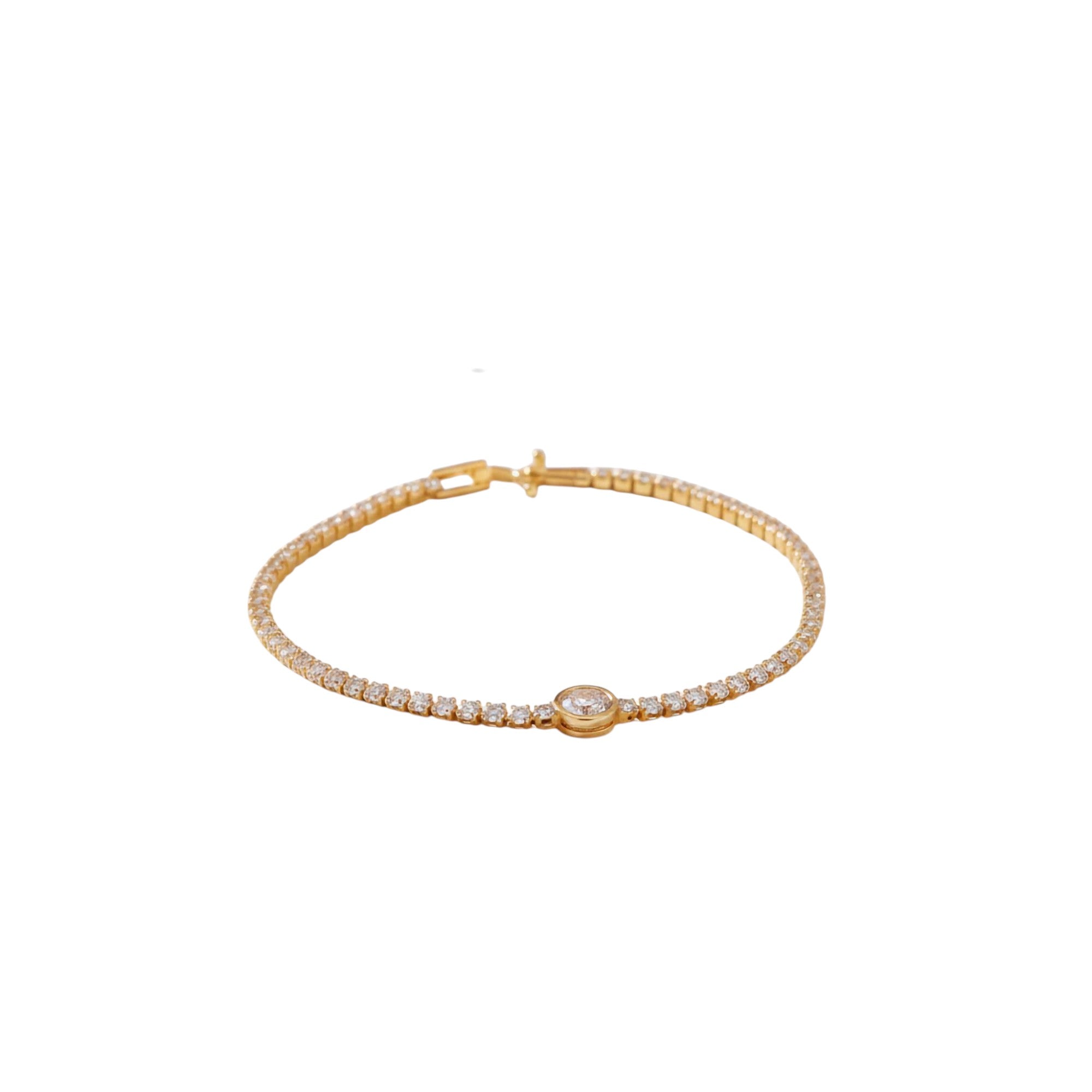 Gold bracelet with a central gemstone on a white background
