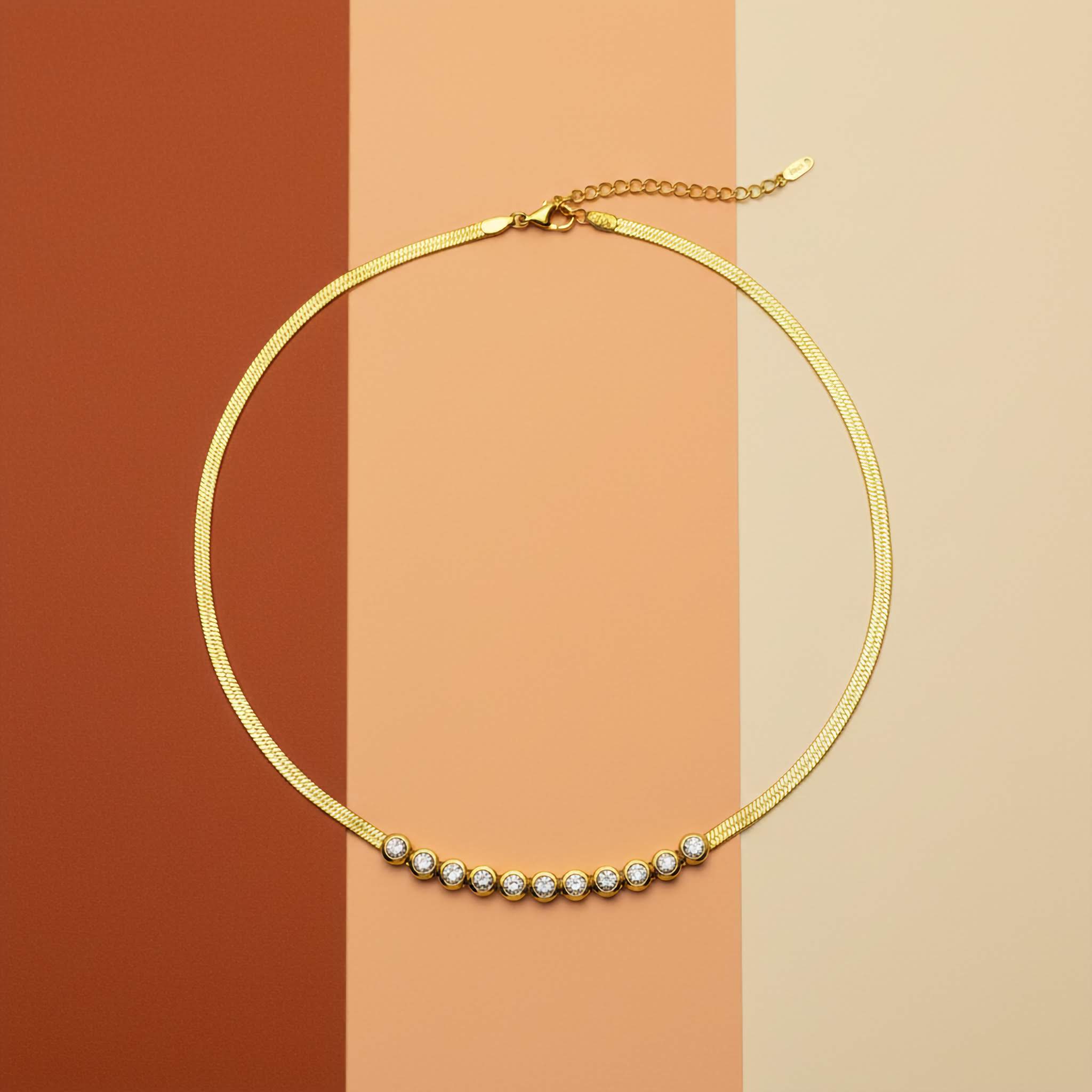 18k Gold plated necklace with clear zirconia diamonds on a two-tone brown background