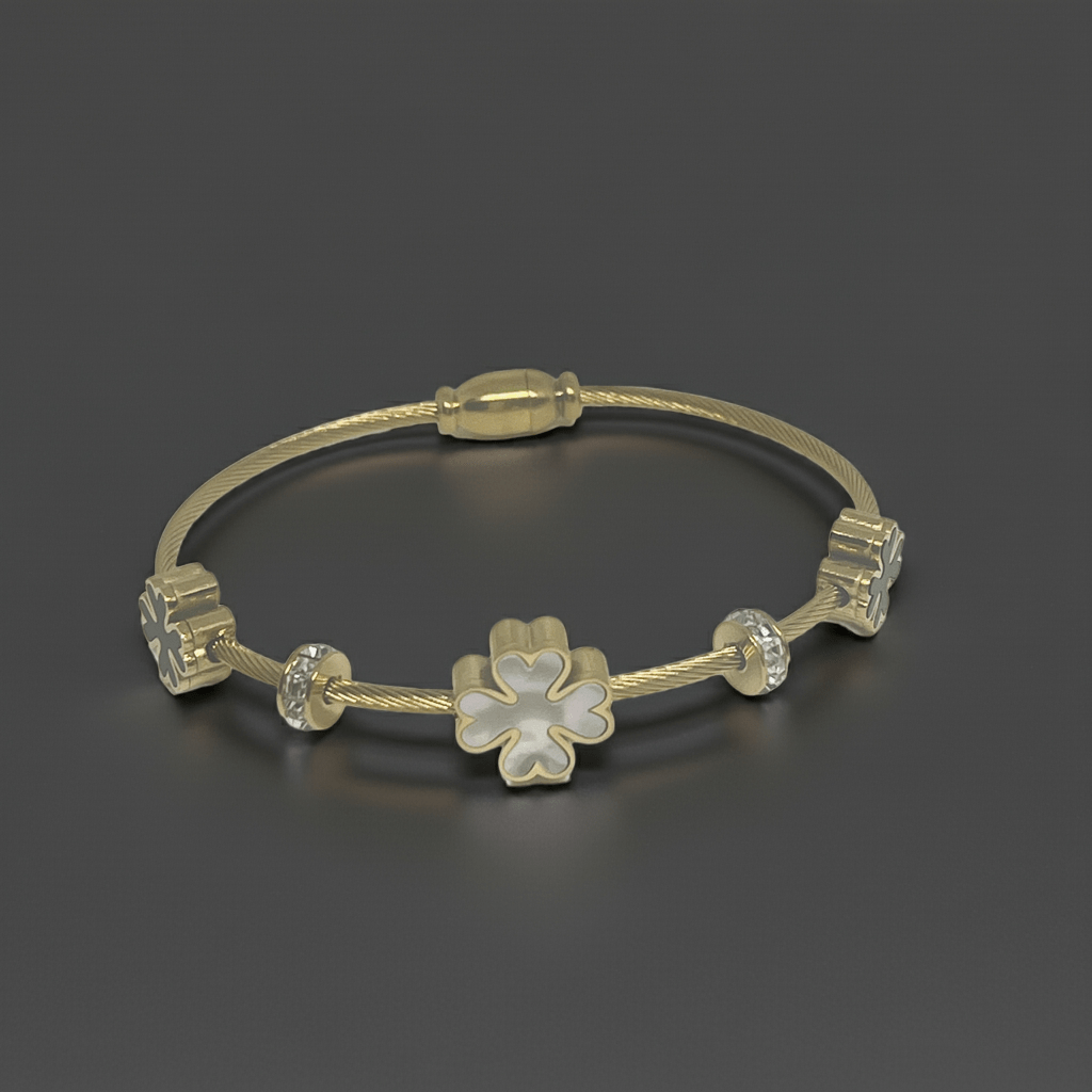 18k gold plated 3 leaf charm bracelet on top of a dark grey background