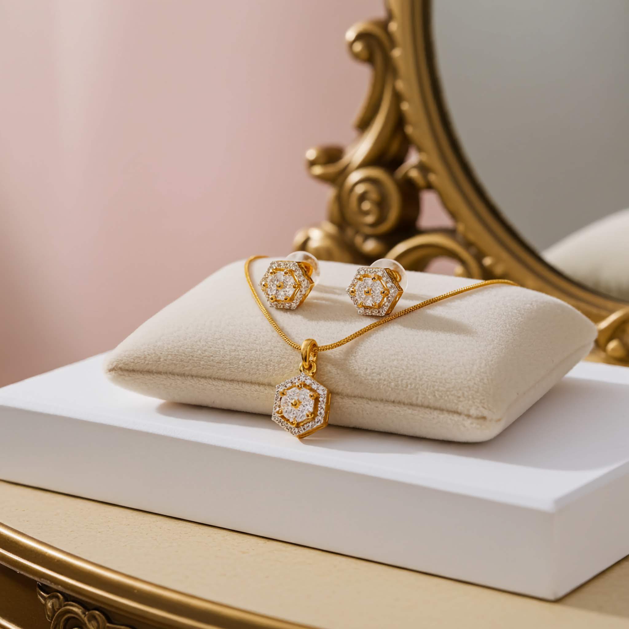 Zirconia 18k Gold plated jewelry set with necklace and earrings on a white pillow in front of a gold-framed mirror.