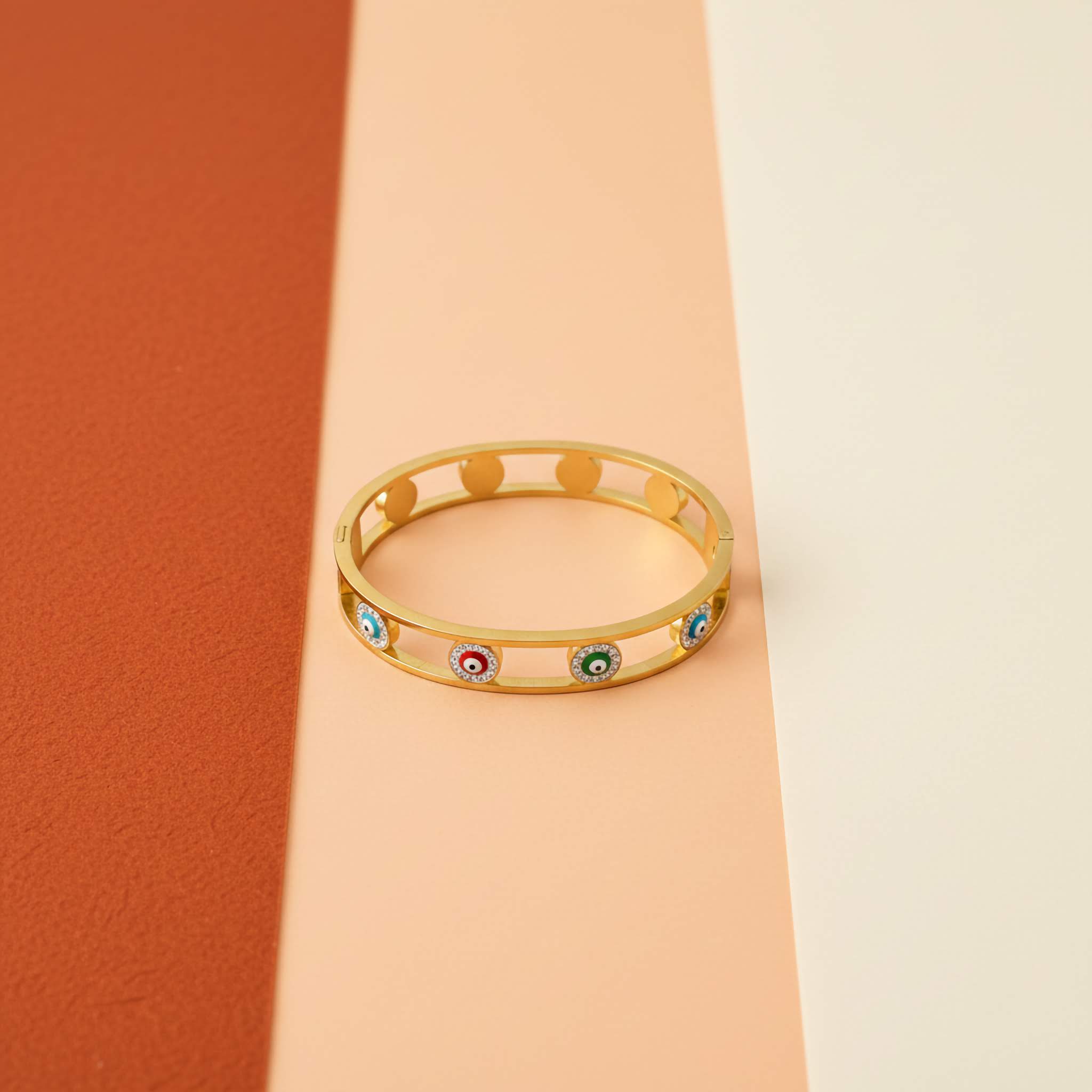 18k gold plated multicoloured evil eye bracelet in multi-coloured background