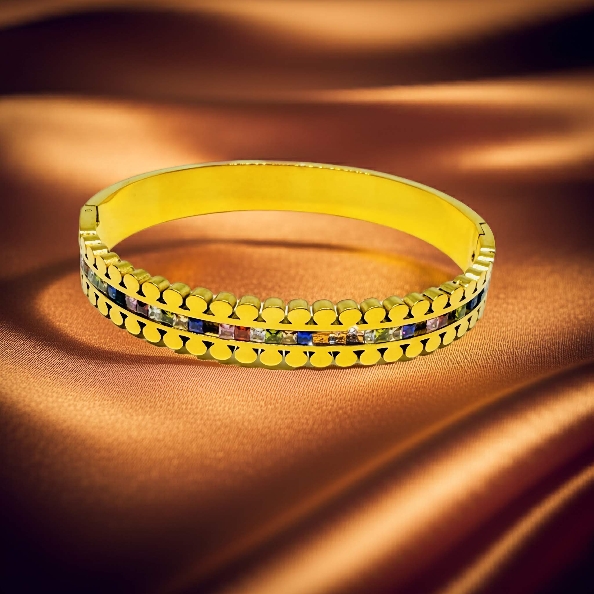 18k gold plated stone work bracelet with blue stones on a brown fabric background