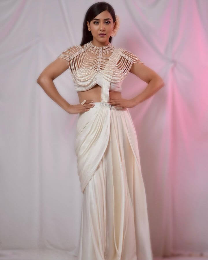 Opulent Pearl Drift Neck Cape worn by a model showcasing elegance and contemporary design in a stunning outfit.