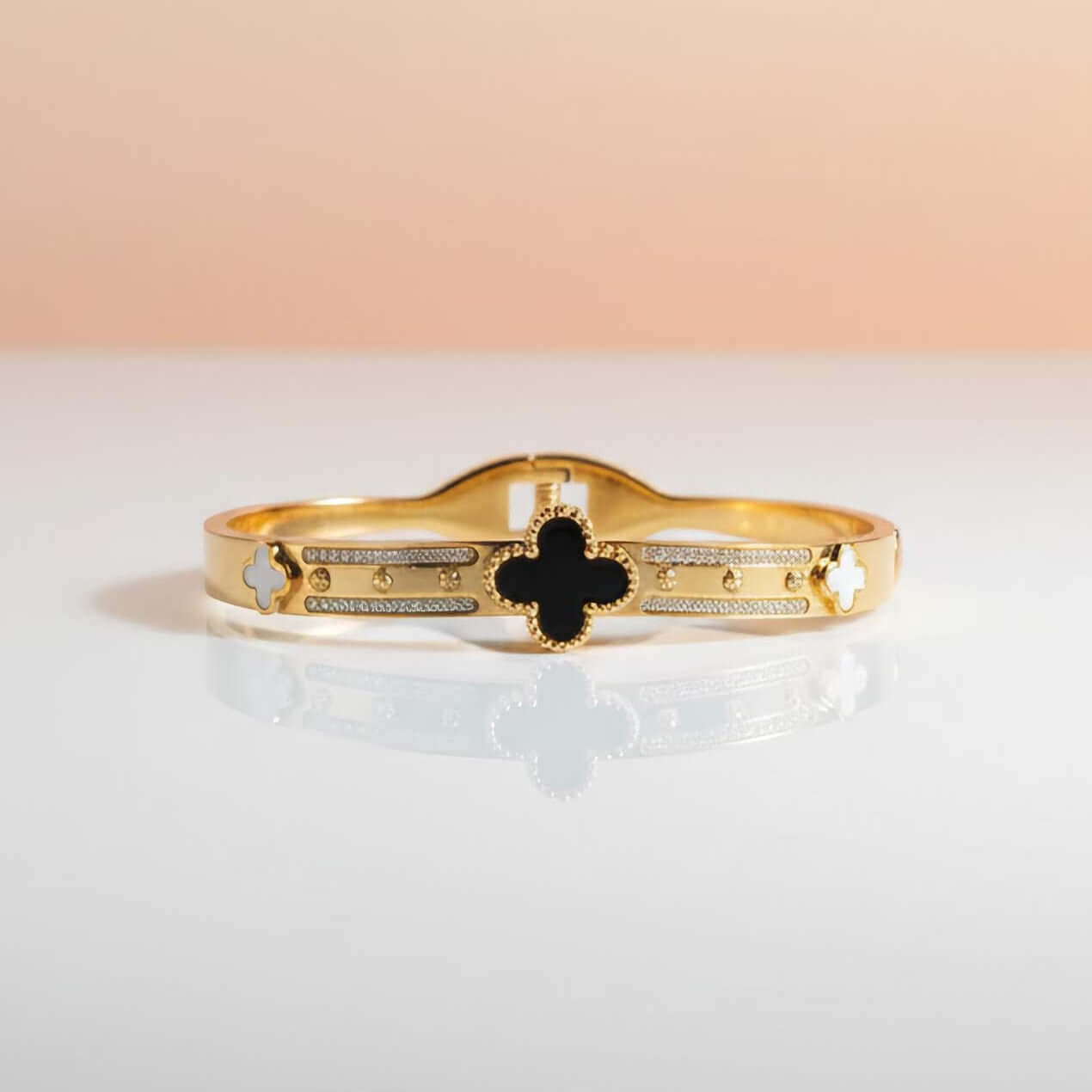 Black and white clover leaf bracelet on a gradient background