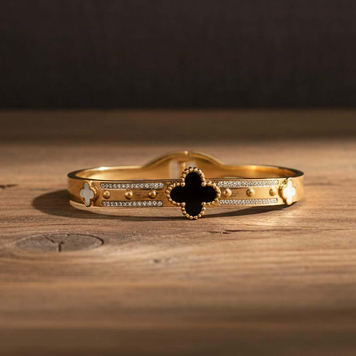 Black and white clover leaf bracelet on a wooden background