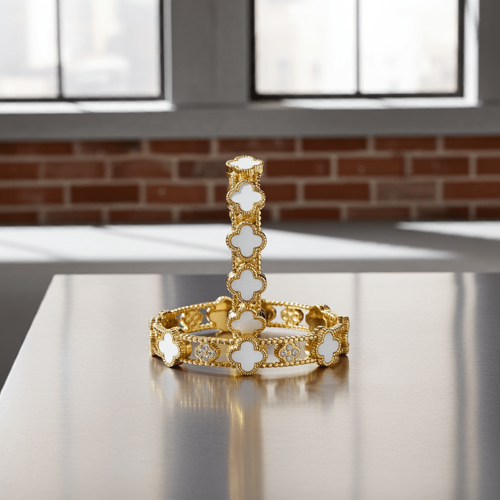 White color clover design gold plated bangle on a white surface.