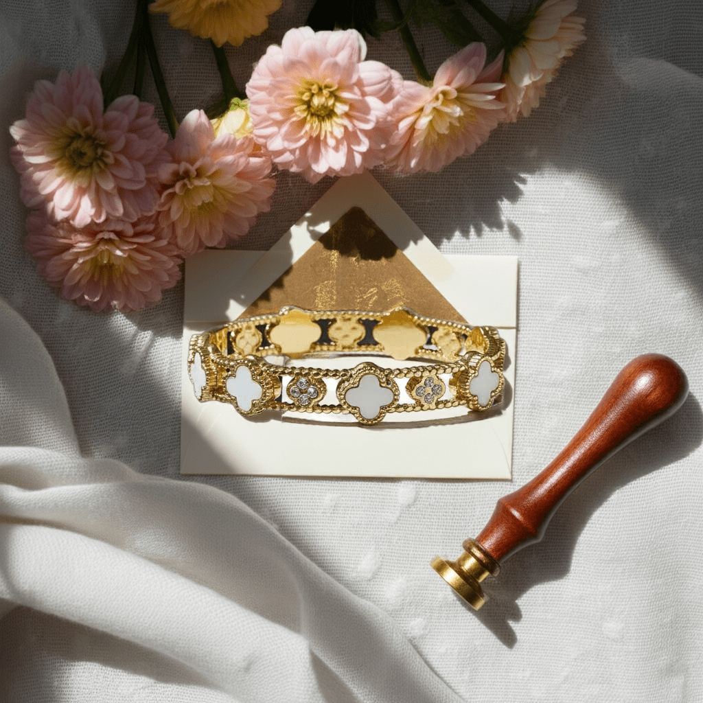 18k gold clover brangle white flower on a white surface with pink flowers