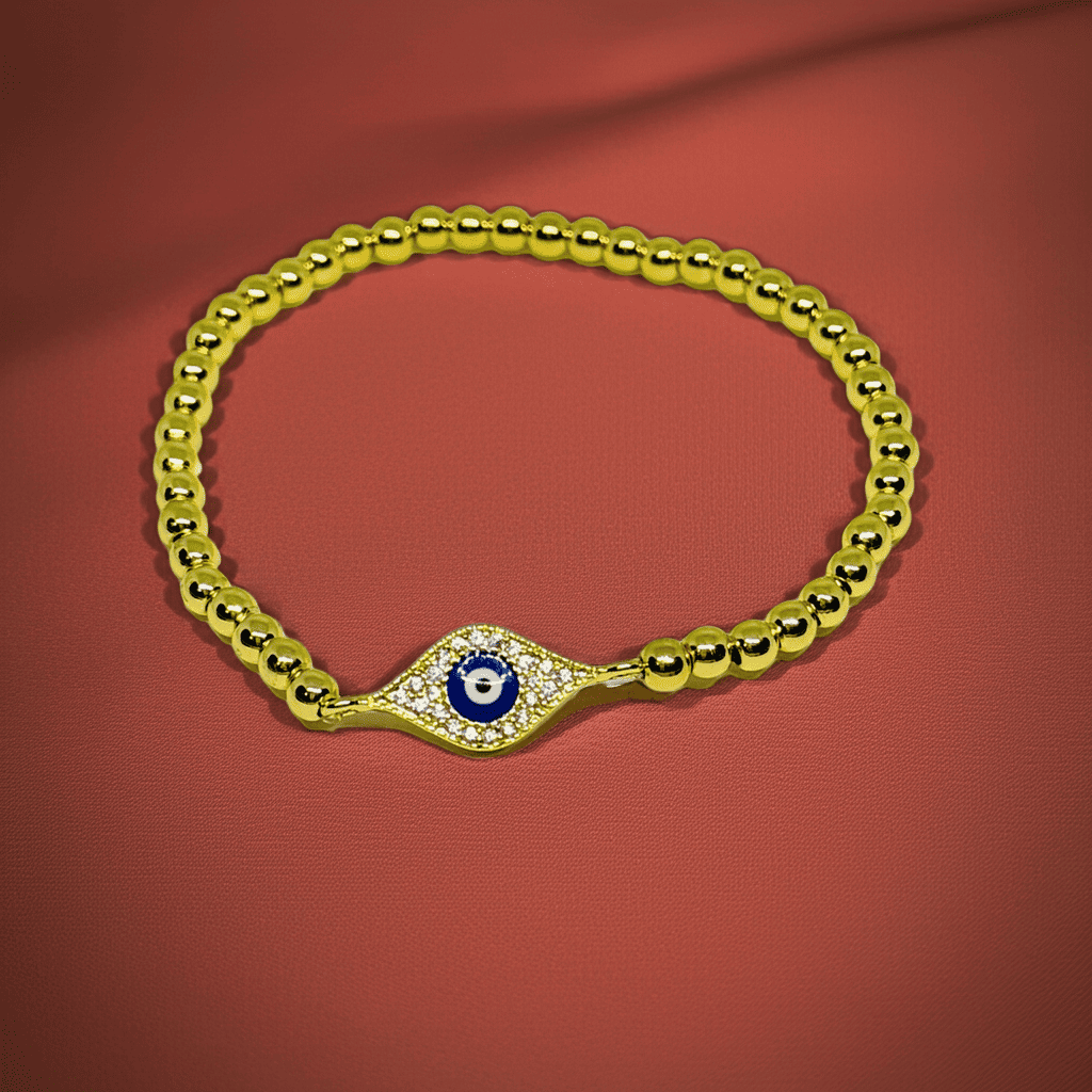 Evil eye slip-on Gold bracelet with a blue evil eye charm on a red background