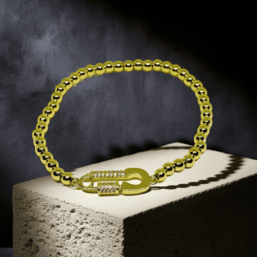 Slip-on Gold bracelet with a lock clasp on a dark background