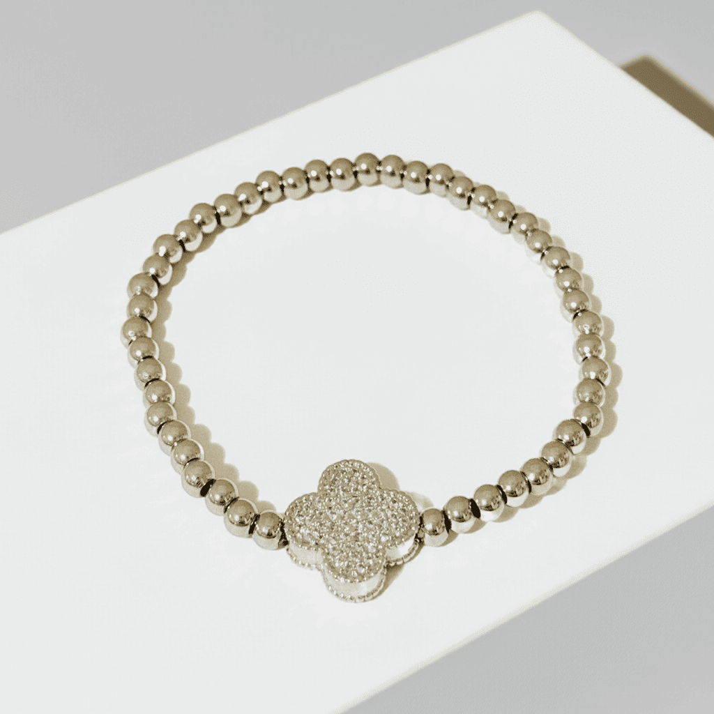 Shop online Silver beaded slip-on bracelet with a heart-shaped charm on a white surface