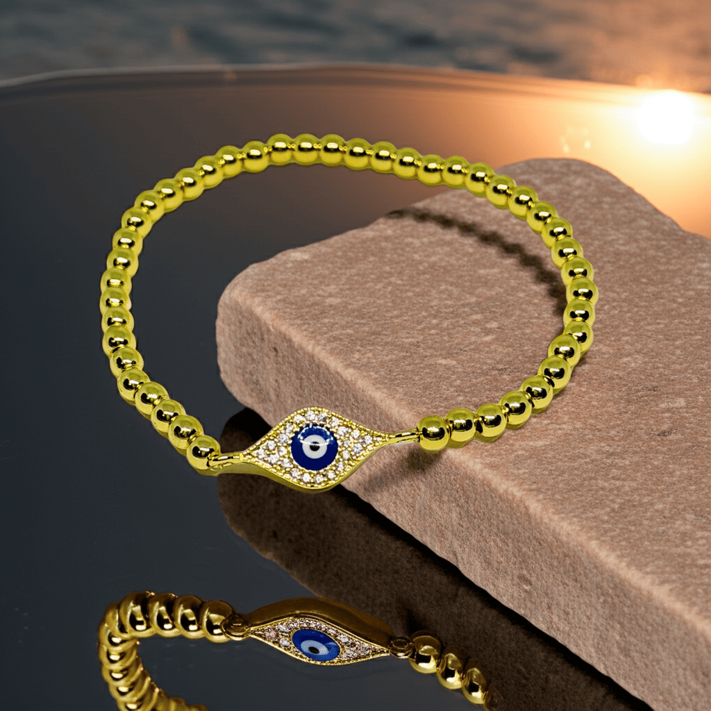 Evil eye slip on Gold bracelet with an eye design on a stone surface
