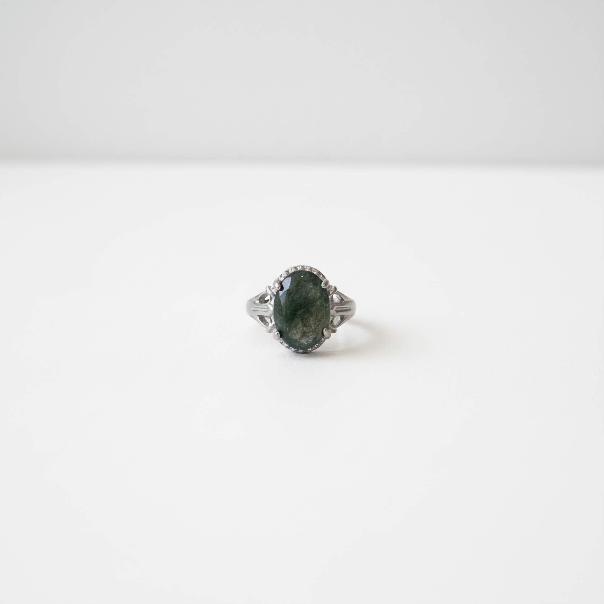Dark green Ring with gemstone on a white background