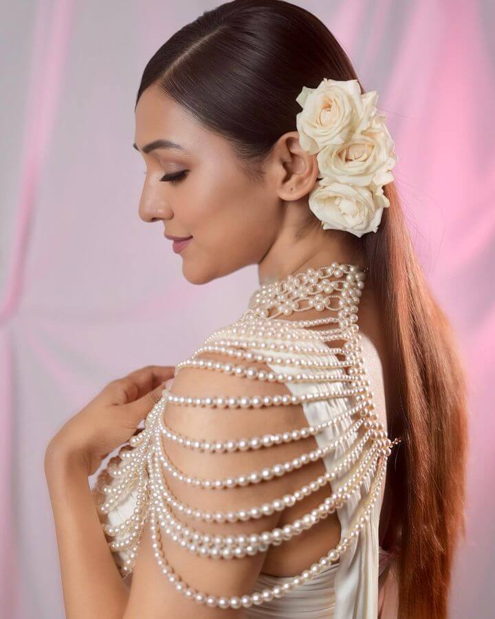 Opulent Pearl Drift Neck Cape styled with pearls and roses, showcasing elegance and sophistication in a luxurious design.