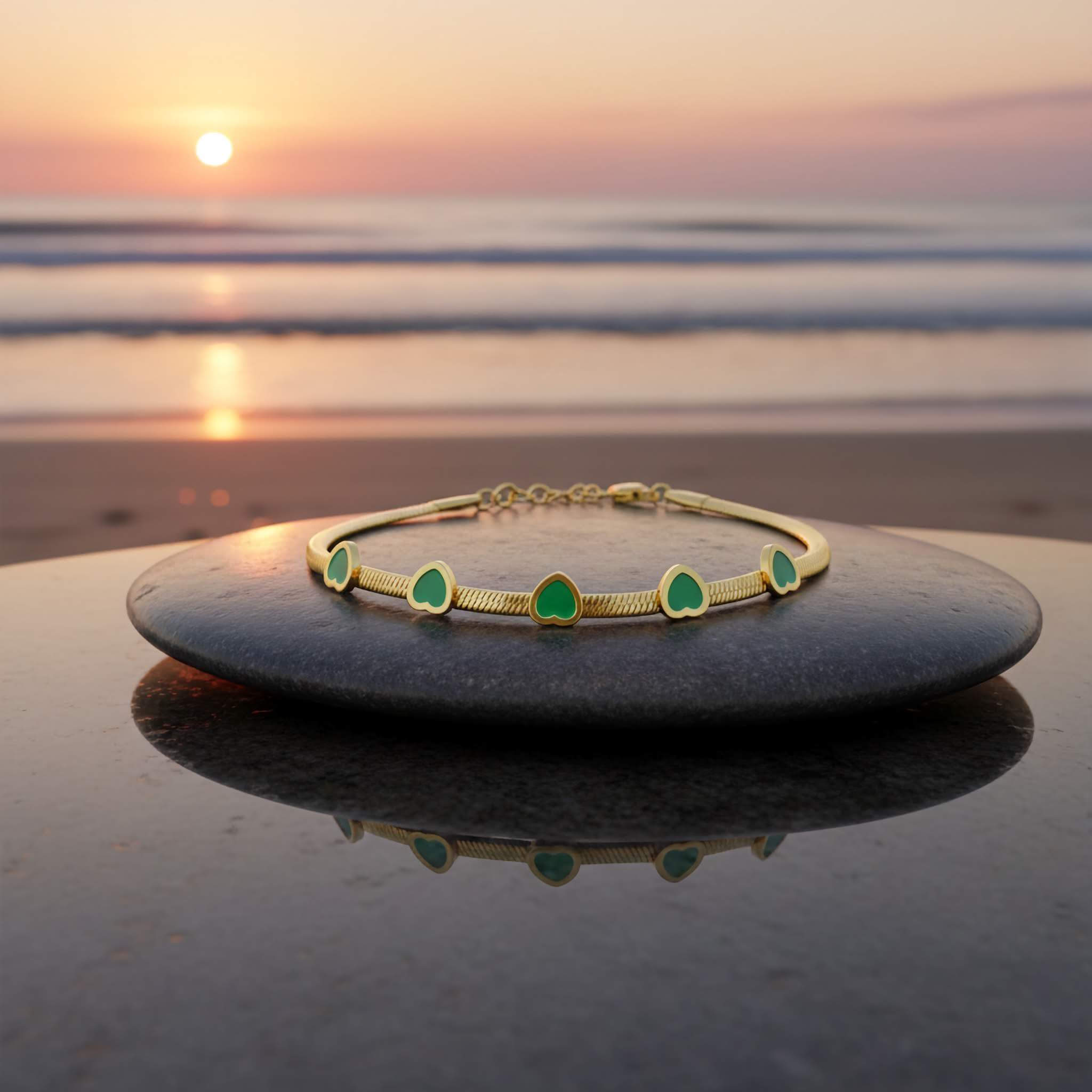 Elegant Green Crystal Braceletwith green stones on a black stone at sunset on the beach