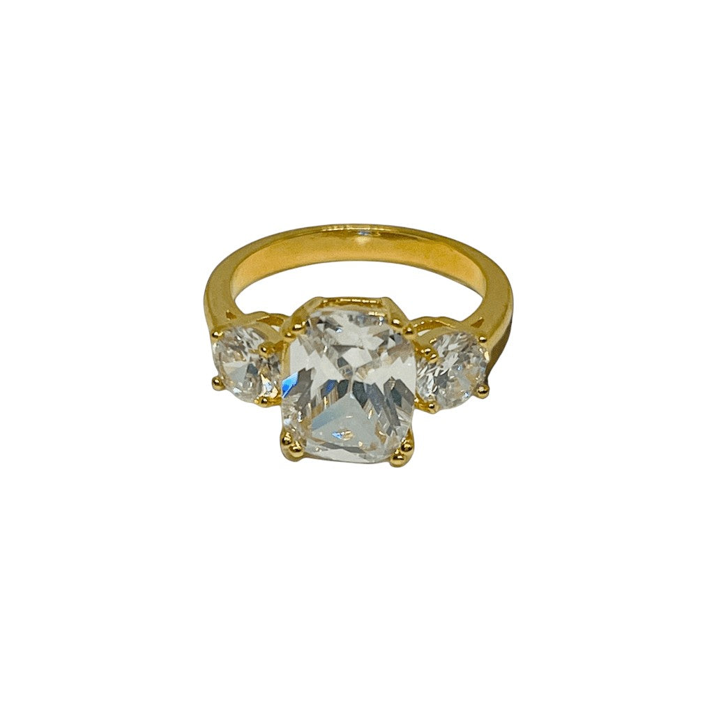 Gold ring with clear gemstones on a white background