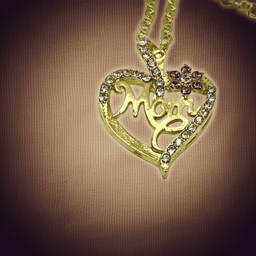 18k Gold heart-shaped pendant with 'Mom' engraved on a brown background