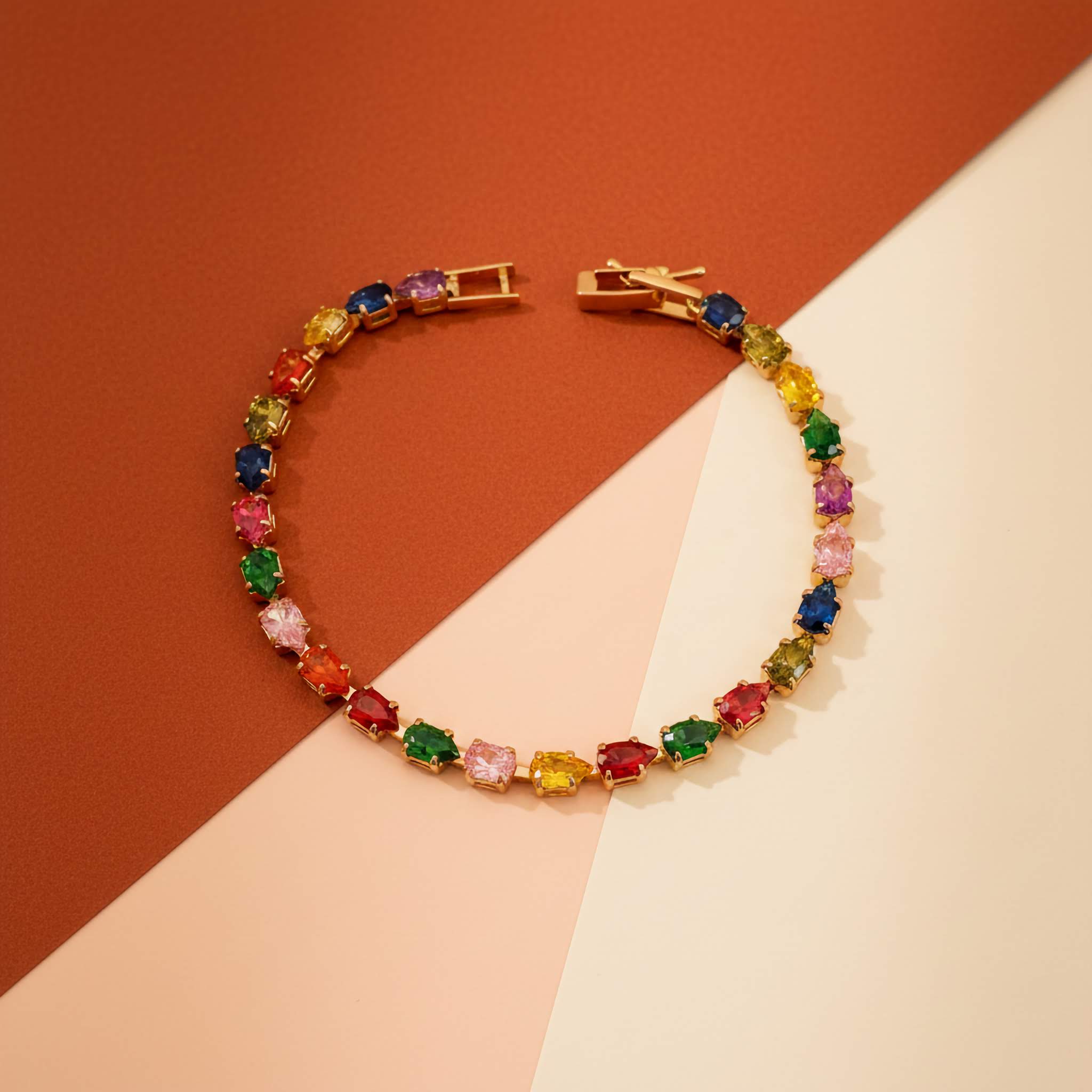 Multi-coloured gemstone tennis bracelet on a two-tone background
