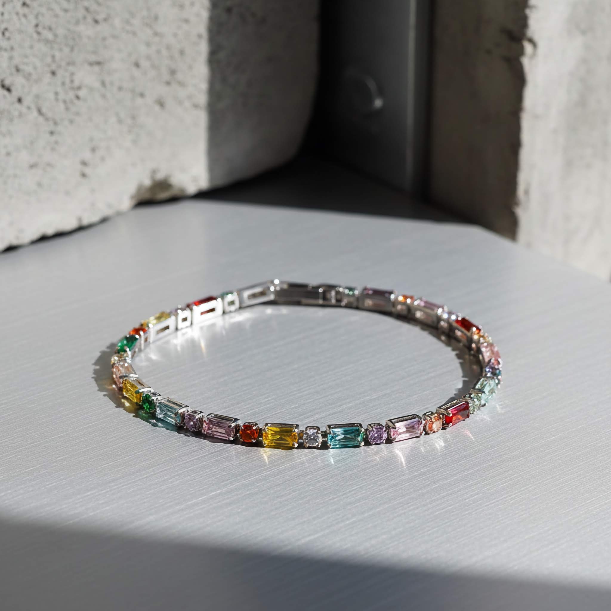 Multicolored gemstone bracelet on a light surface with a neutral background