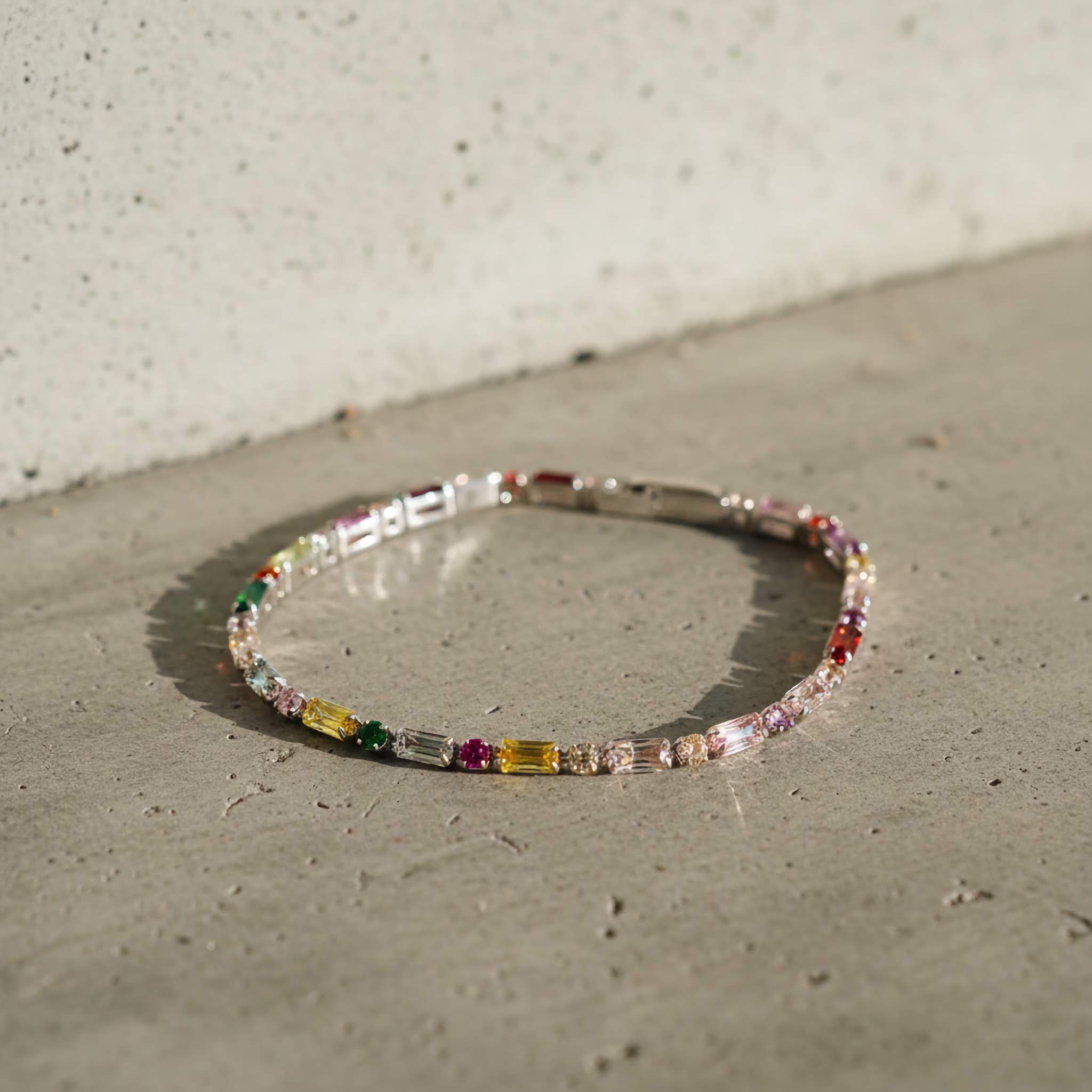 Multicolored silver pated beaded bracelet on a concrete surface