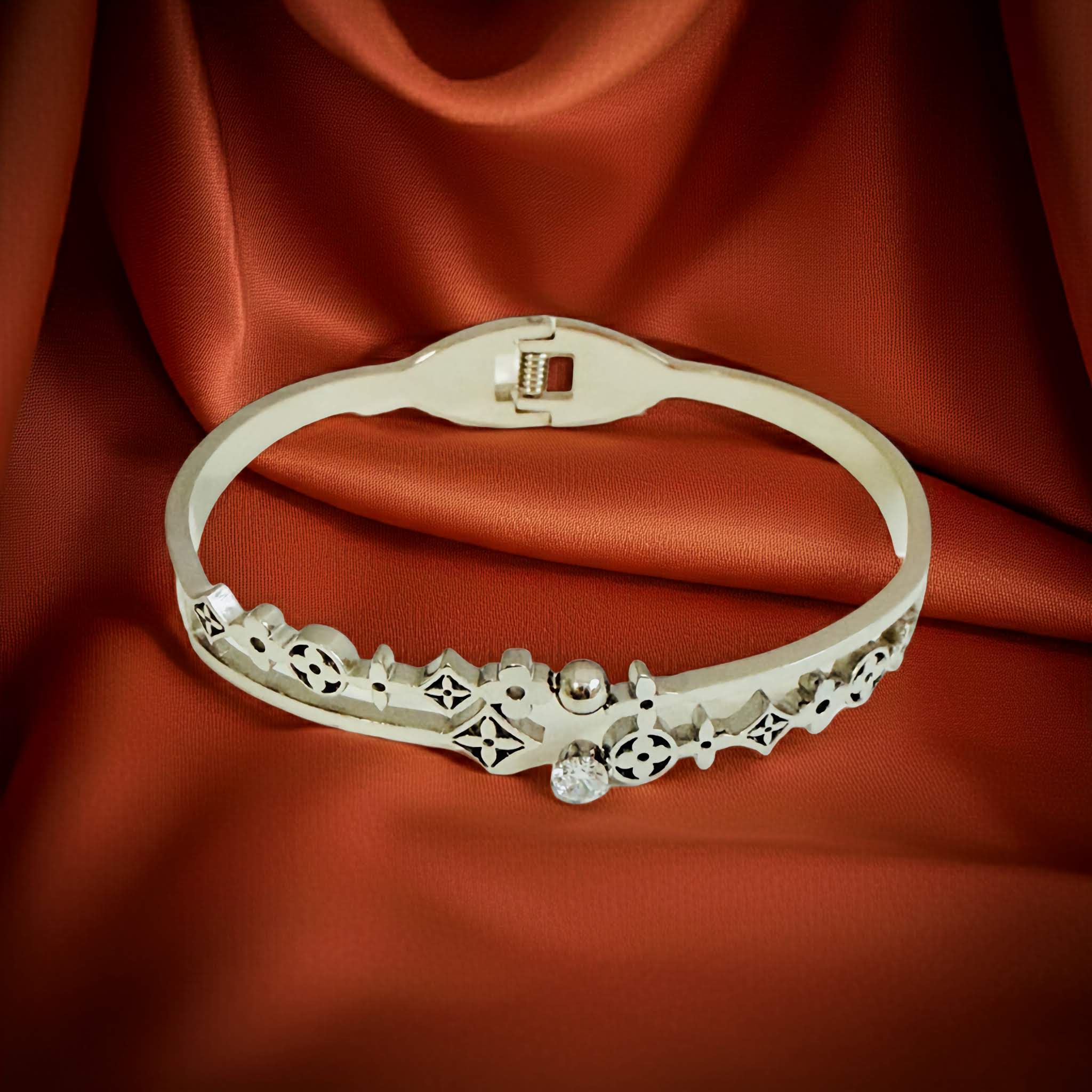 Decorative Oxidized silver bracelet on a red fabric background
