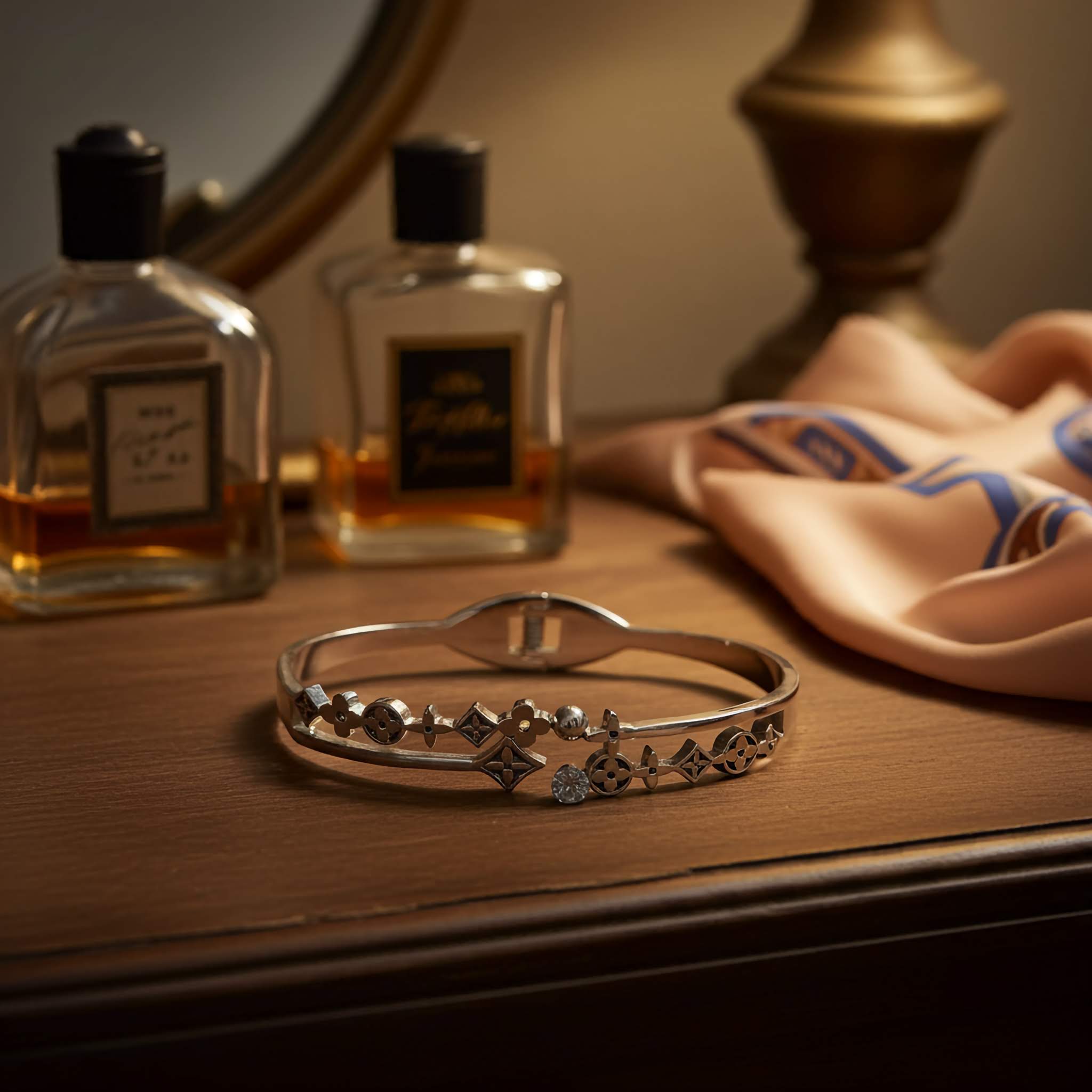 Oxidized Silver bracelet on a wooden surface with perfume bottles and a scarf in the background