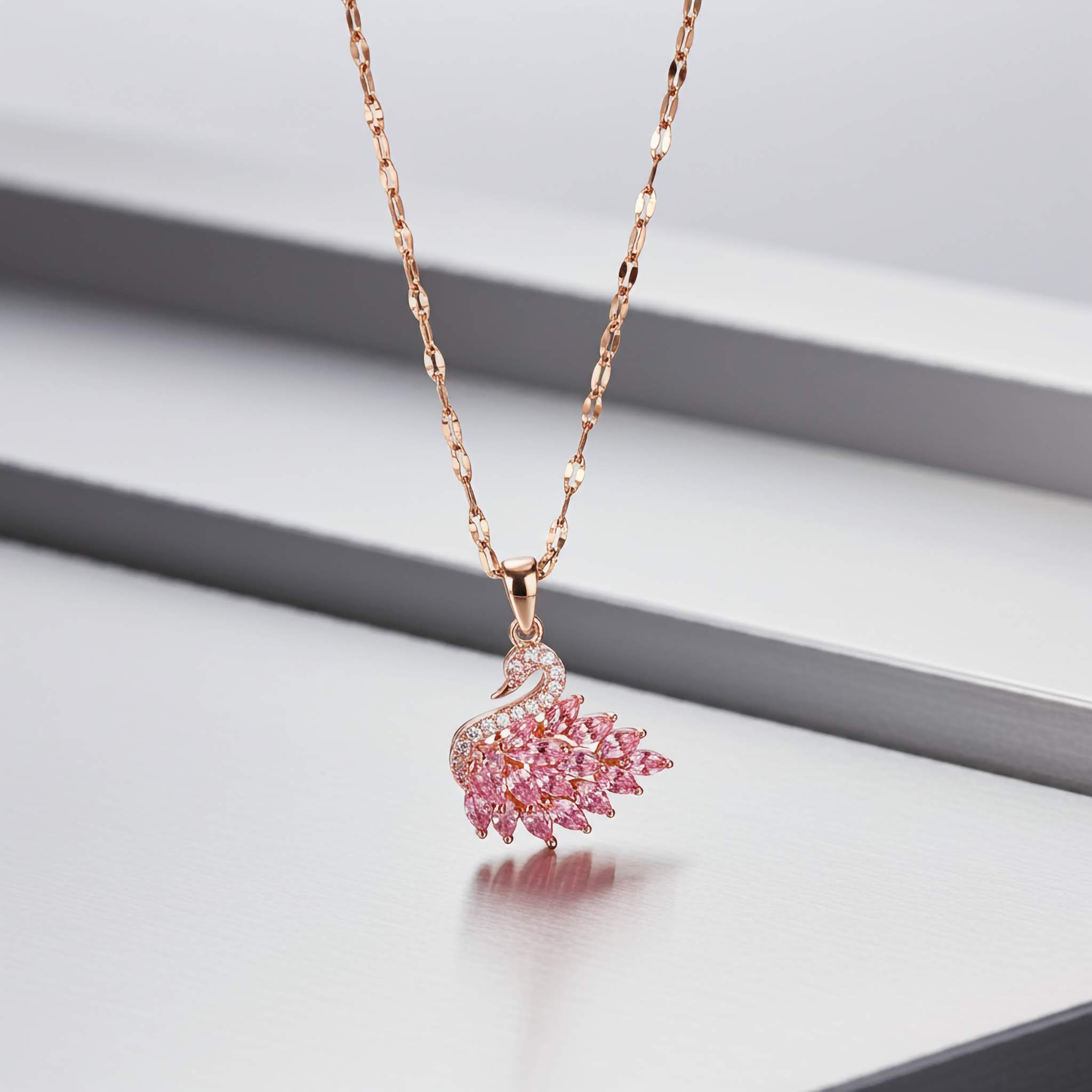 Pink crystal swan pendant Necklacet on a light gray background