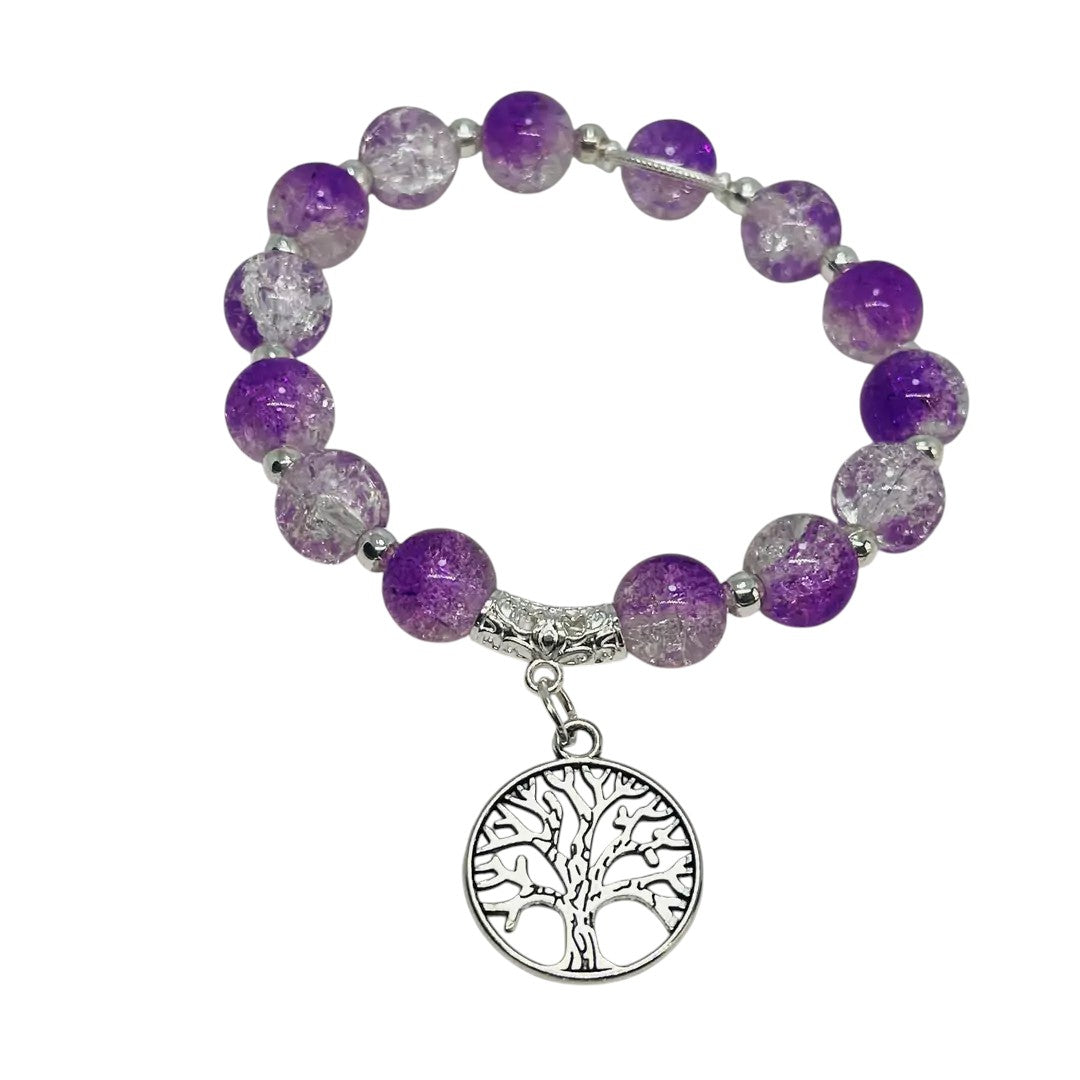Bracelet with purple beads and a silver tree of life charm on a white background