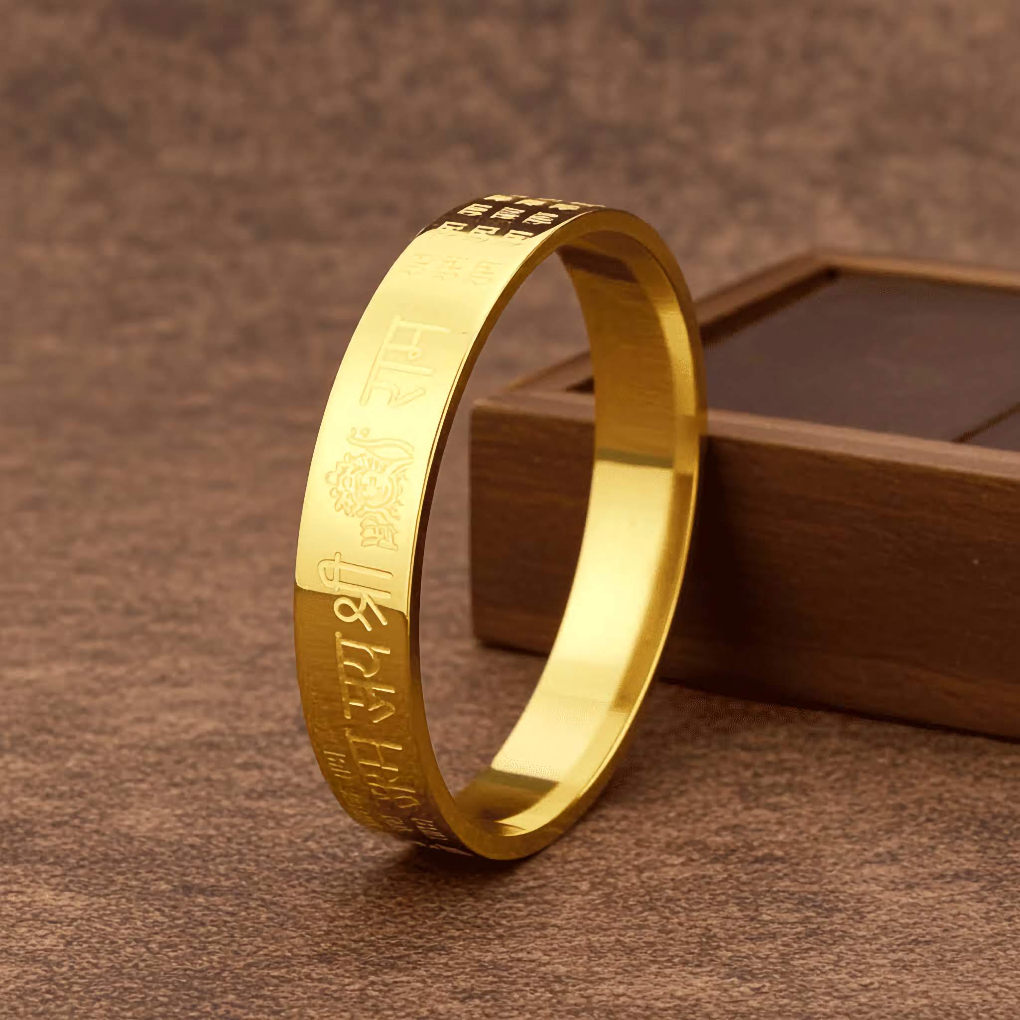 A Gold Ram bracelet with engraved Jai Shree Ram text on a brown textured surface