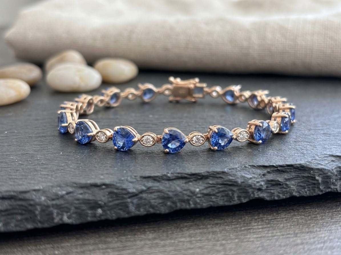 Blue heart-shaped stones with small clear accents; adjustable stainless steel bracelet by LeDeSaRa