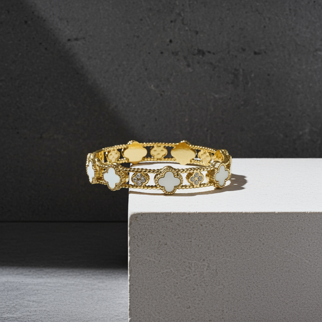 White color Gold bracelet with intricate design on a gray surface