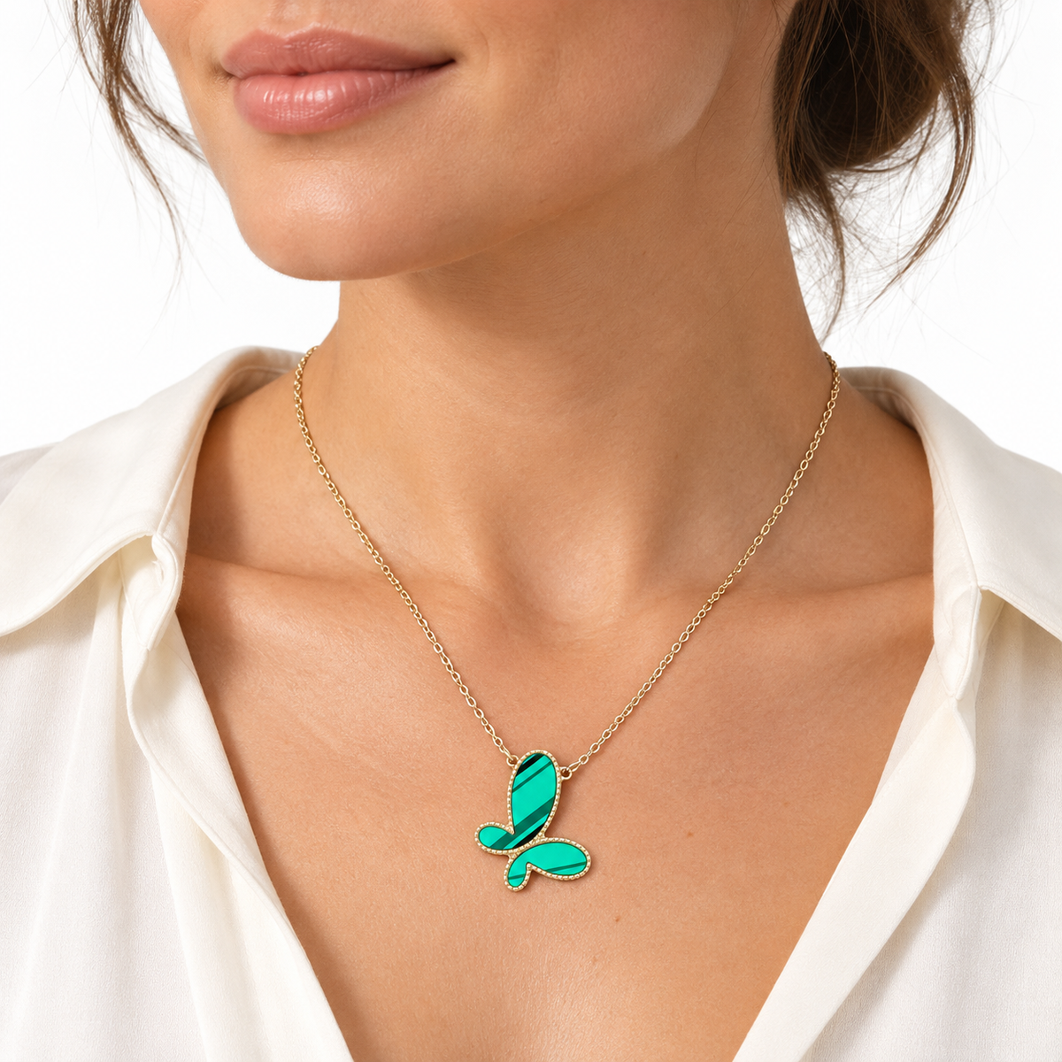 Model wearing LeDeSaRa green butterfly pendant necklace with a gold-tone chain