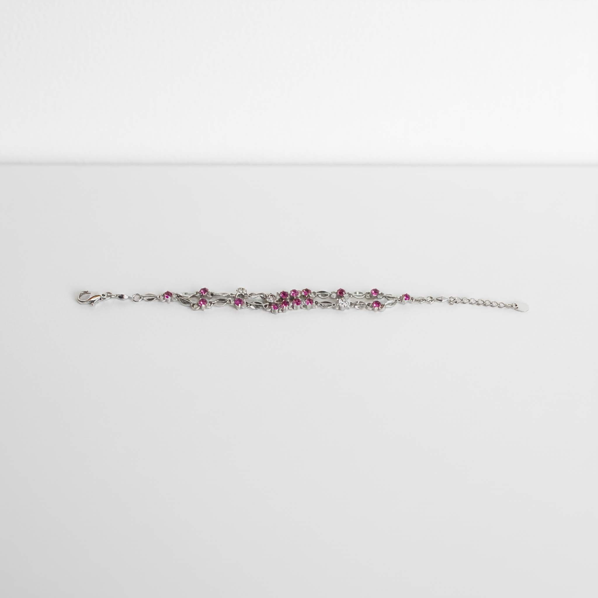 oxidized bracelet with pink stones on a white background