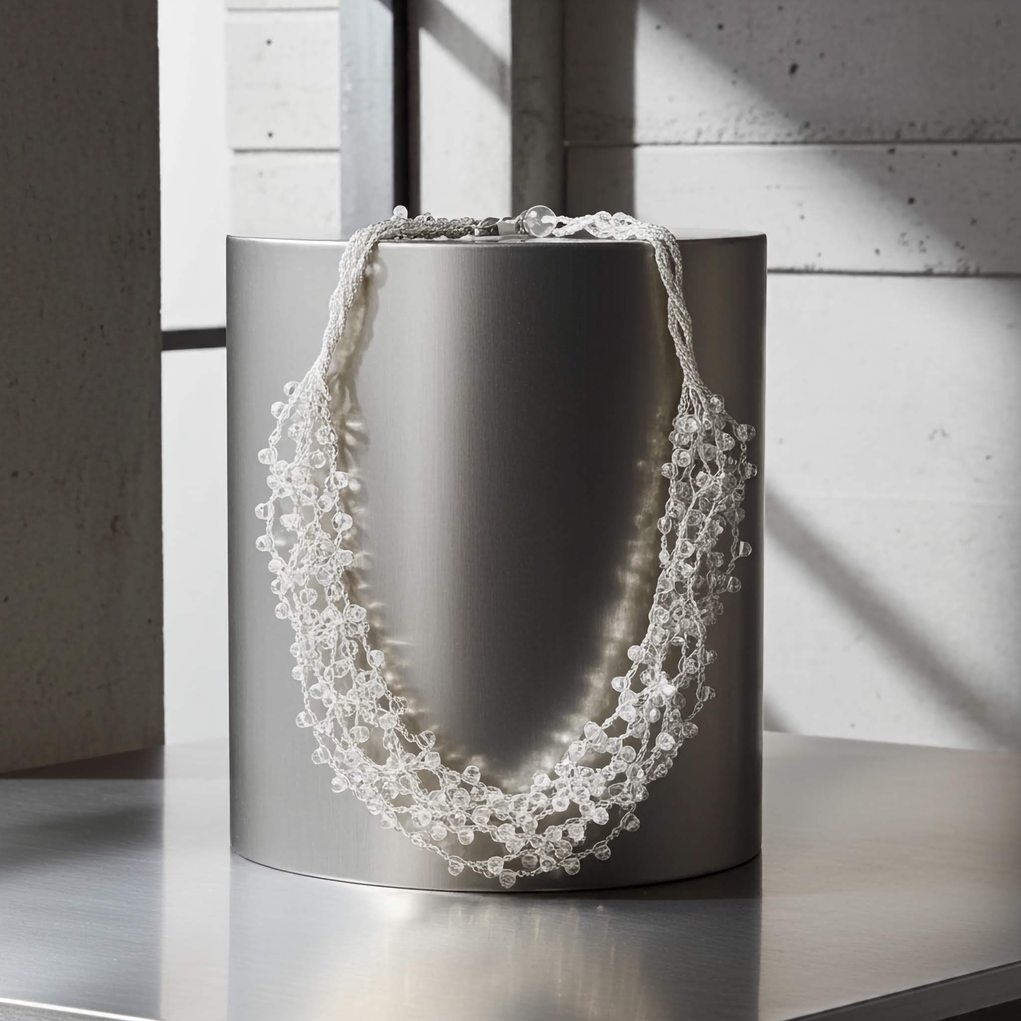 $10 Beaded necklace on a metallic cylindrical container against a neutral background