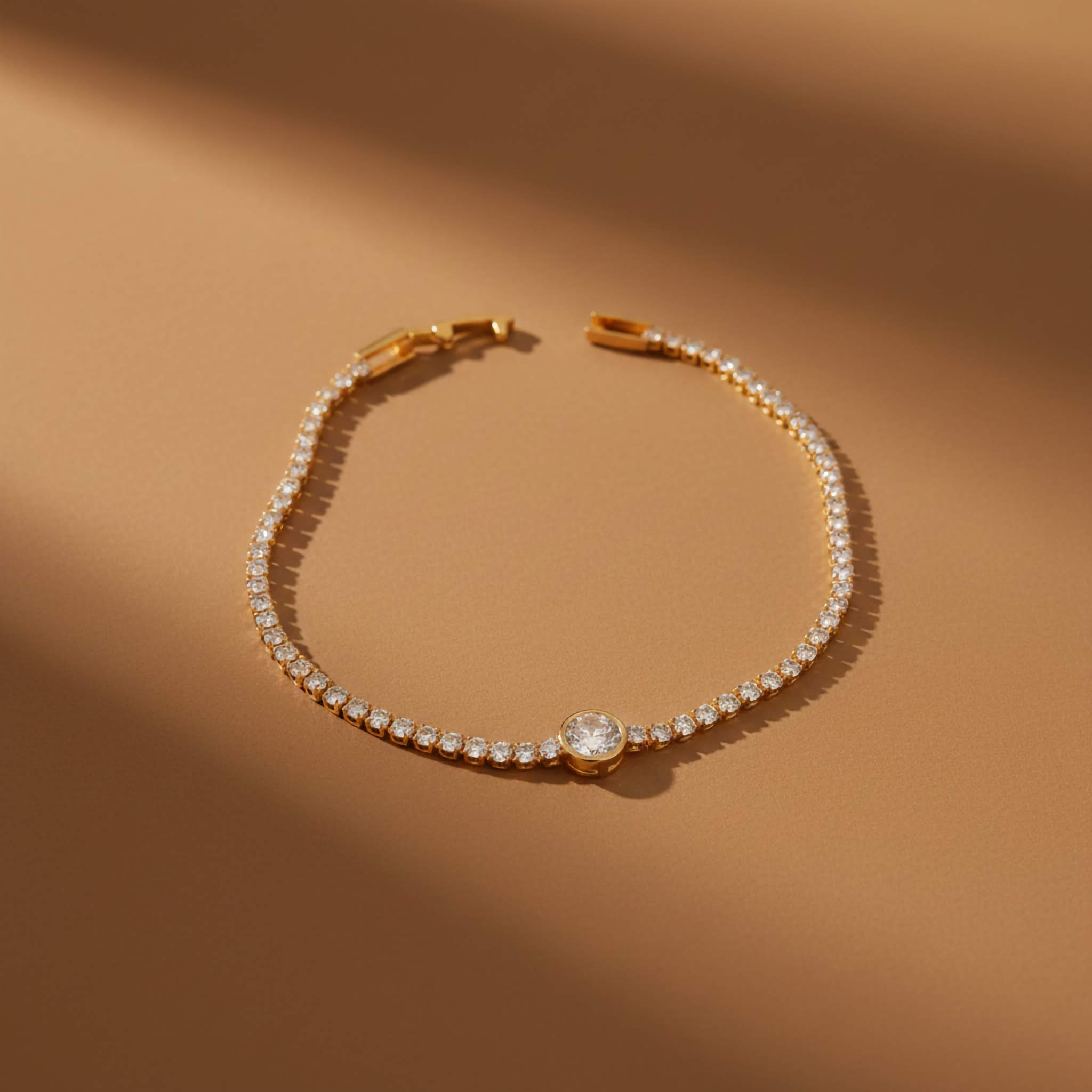 Clear crystal Gold plated bracelet with clear gemstones on a brown background