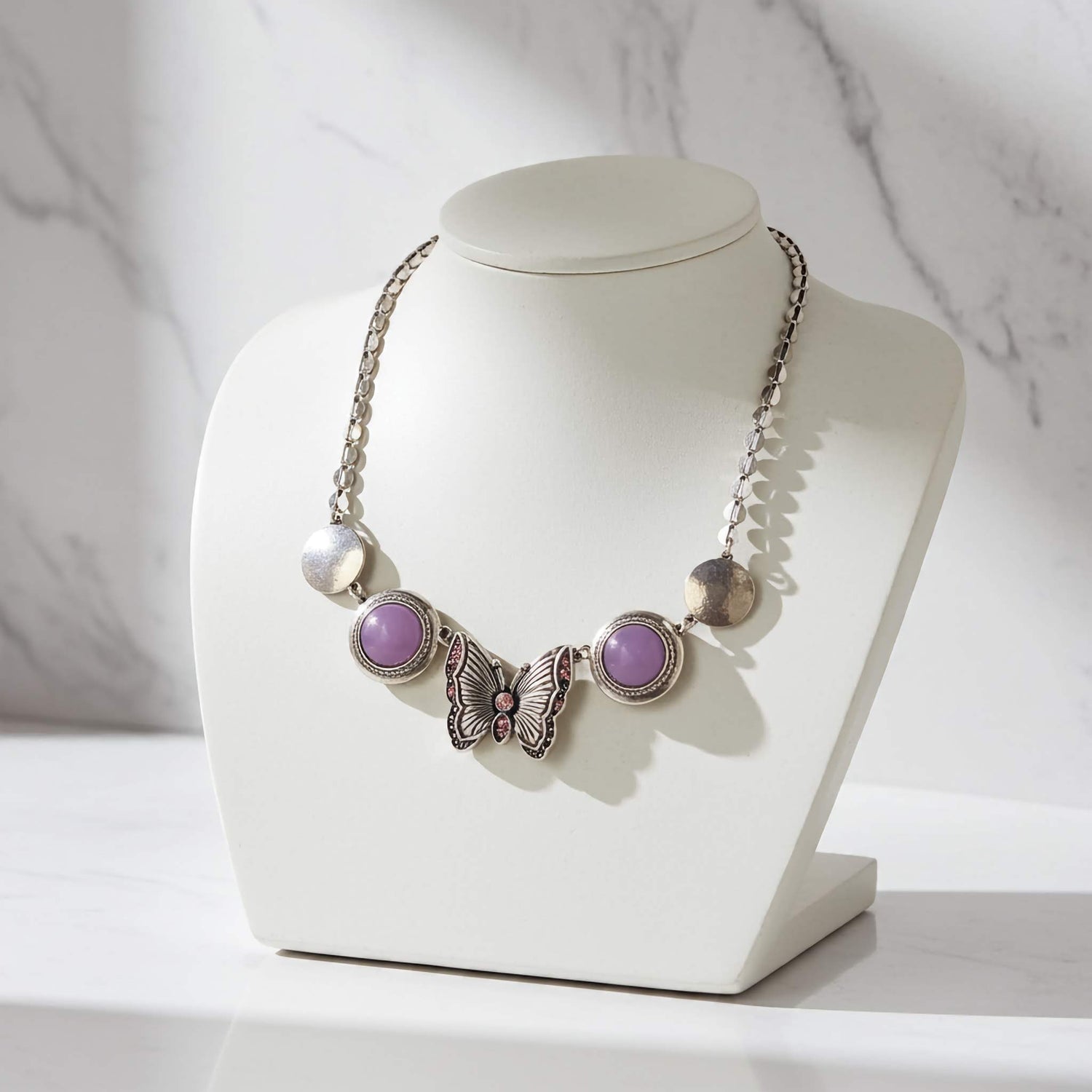 Beautiful butterfly necklace showcasing affordable imitation jewelry on a display bust.