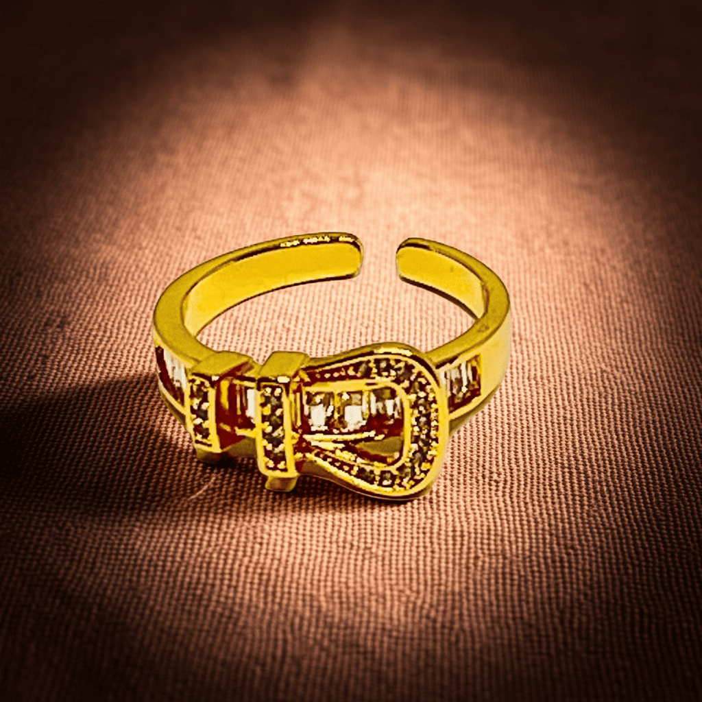 18k Gold ring with a buckle design on a brown textured background